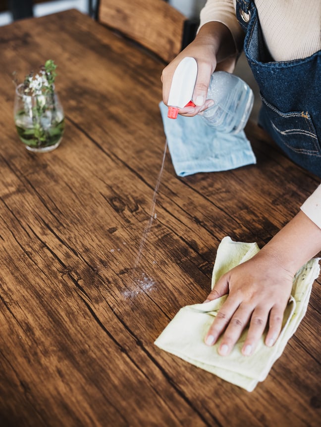 Cleaner Spraying and Wiping Wooden Table